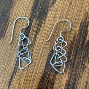 Dangly real silver earrings made up of interlocking triangles